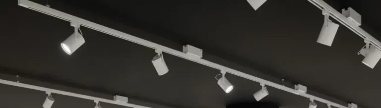 Clothing retail floor lit by white track spotlights along the ceiling